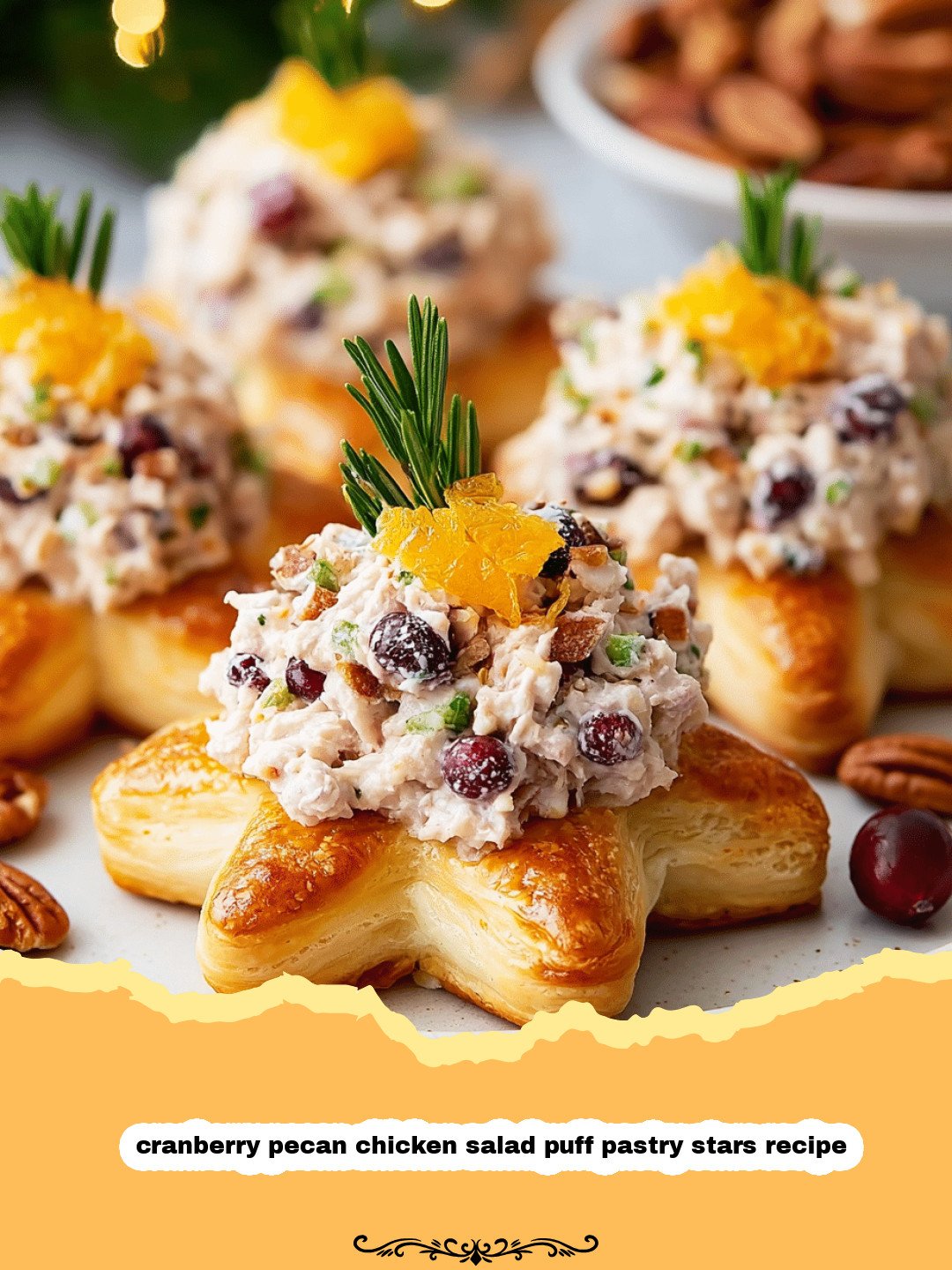Golden puff pastry stars filled with cranberry pecan chicken salad on a platter.