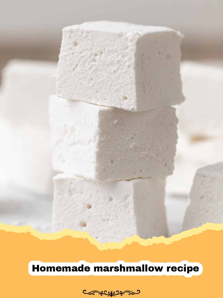 Pile of fluffy homemade vanilla marshmallows dusted with powdered sugar, ready for hot chocolate or s'mores.