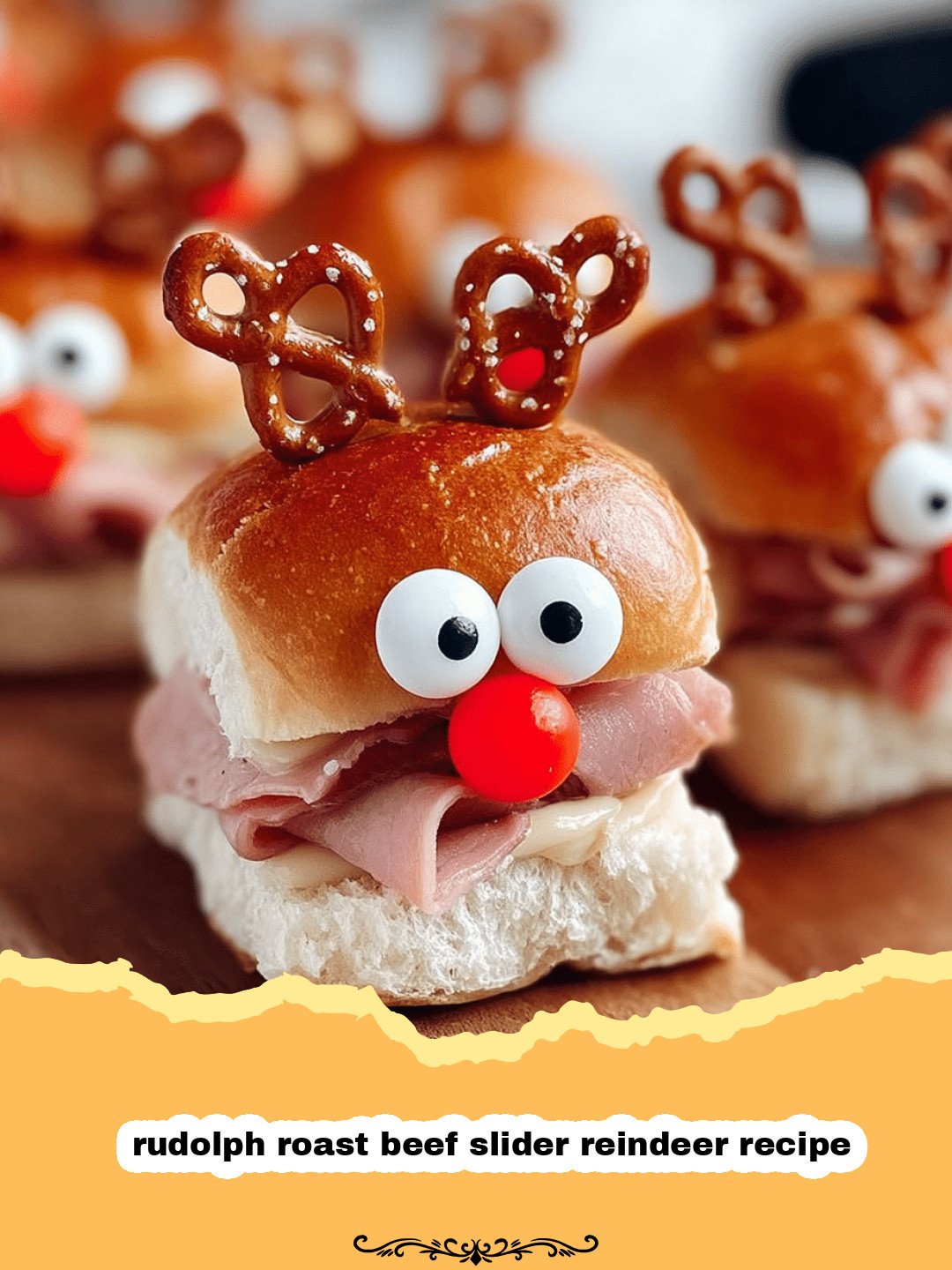 Rudolph Roast Beef Sliders arranged on a platter, decorated with pretzel antlers, olive eyes, and a bright red pepper nose, with festive holiday decor in the background.