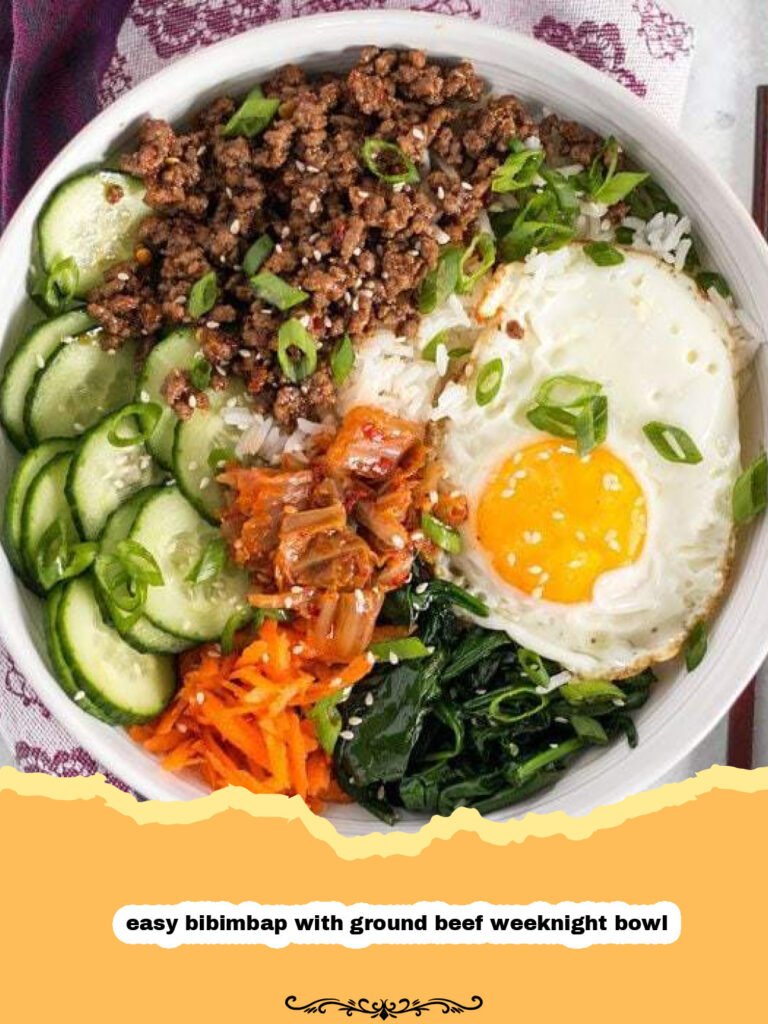 The Ultimate Easy Bibimbap with Ground Beef: Your Go-To Weeknight Bowl! 5 A vibrant easy bibimbap with ground beef weeknight bowl topped with a fried egg, colorful sautéed vegetables, and a drizzle of spicy gochujang sauce.