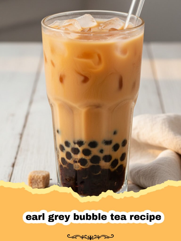 earl grey bubble tea recipe - A tall glass of Earl Grey bubble tea with dark pearls at the bottom and a creamy tea layer on top.