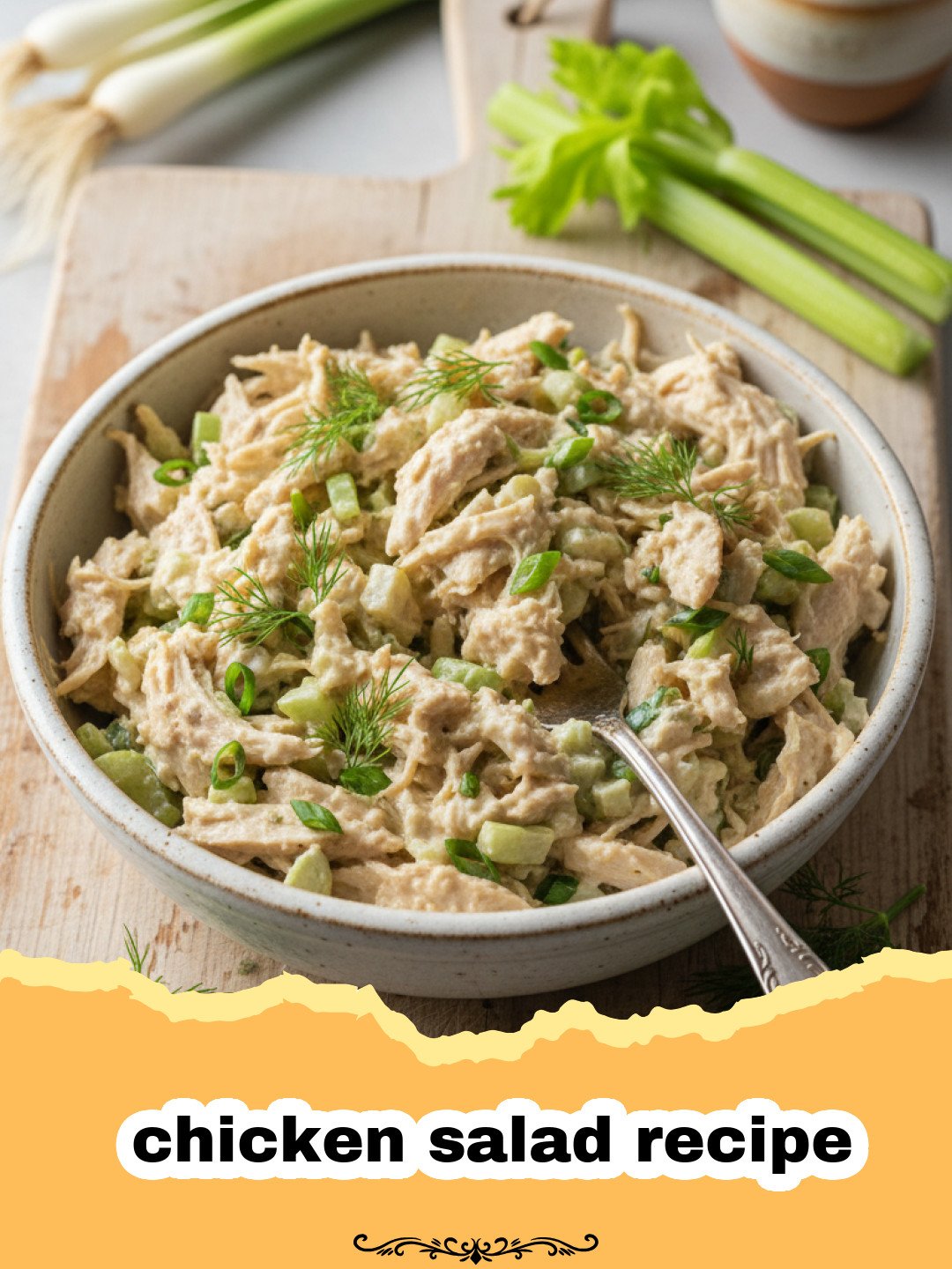 The Ultimate Creamy Classic Chicken Salad 3 chicken salad recipe - A bowl of creamy chicken salad with grapes and pecans on a wooden table.