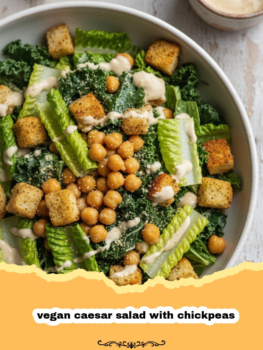 A large bowl of vegan caesar salad with chickpeas and creamy dressing