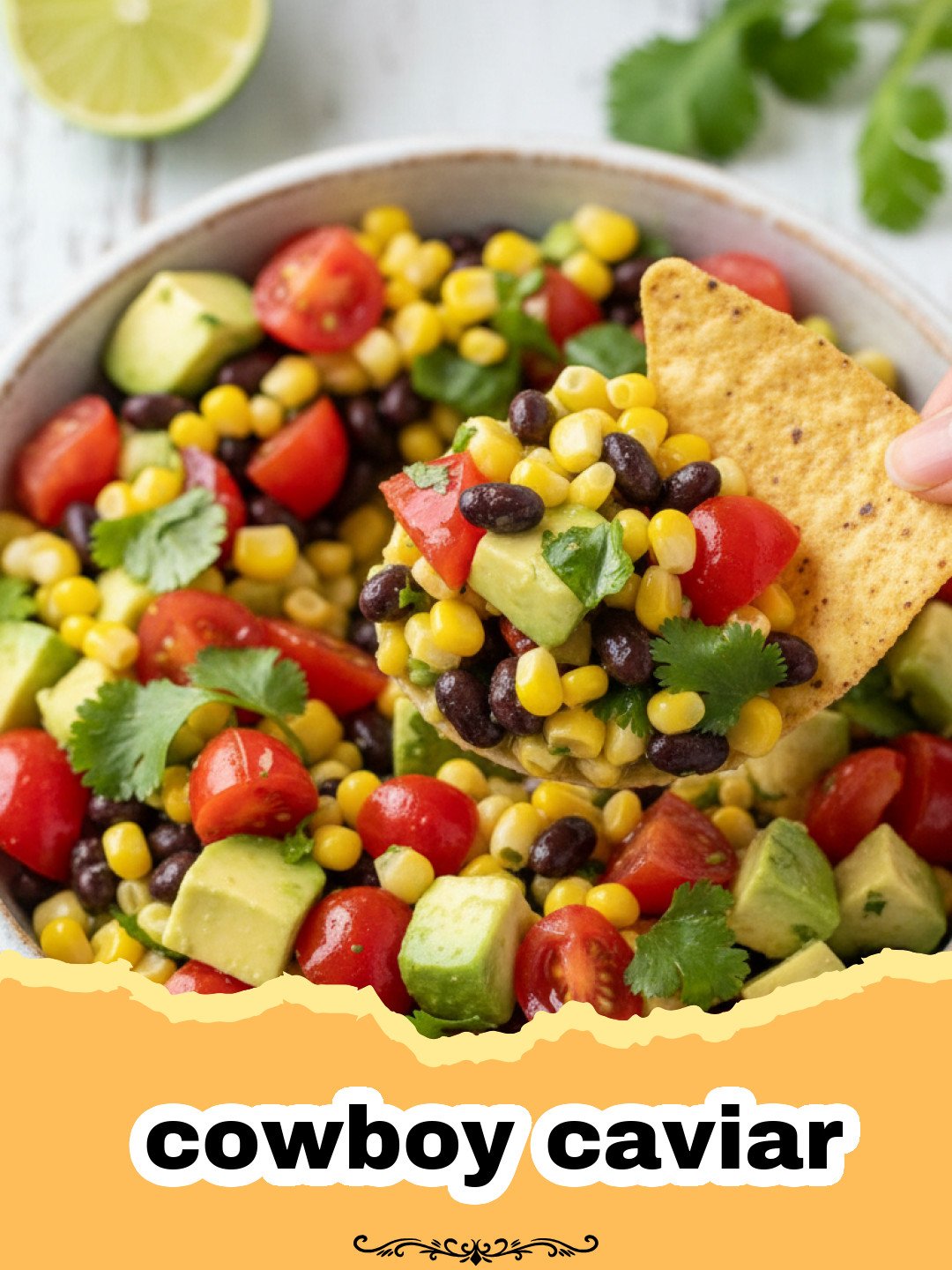 Close-up of vibrant cowboy caviar in a glass bowl with tortilla chips around it.