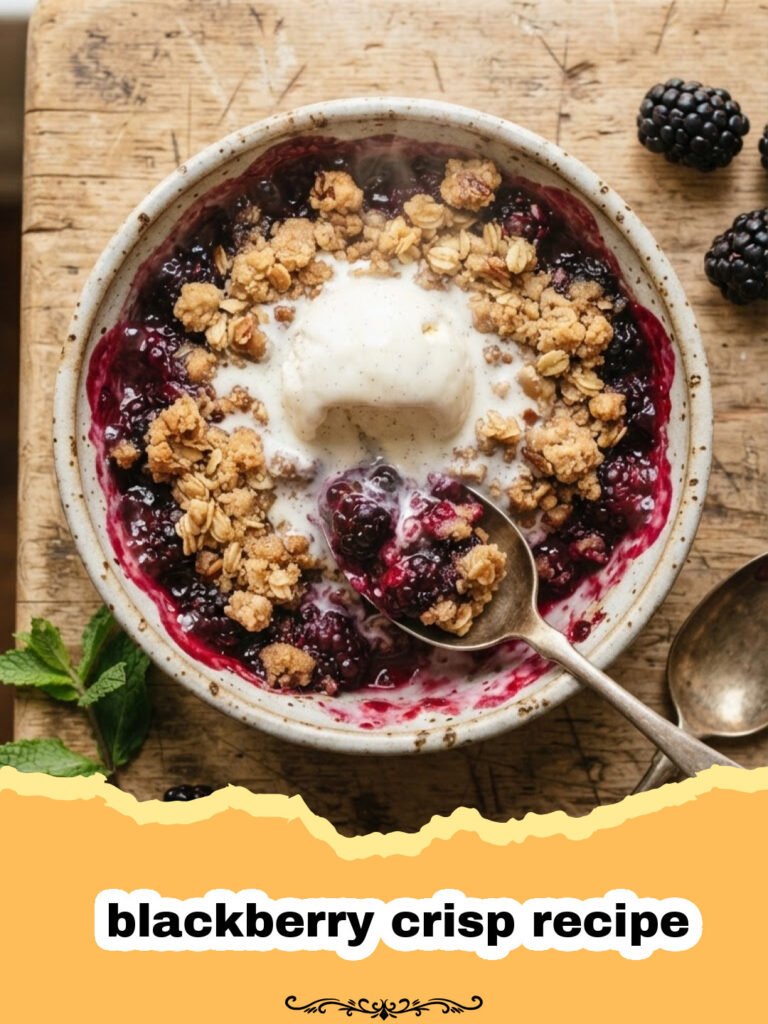 blackberry crisp recipe - A golden brown blackberry crisp in a white baking dish with bubbling purple juices.