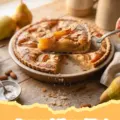 A golden-brown Pear and Almond Tart with fanned pear slices and a glossy apricot glaze.