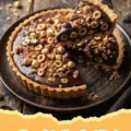 Chocolate Hazelnut Tart - A slice of decadent chocolate hazelnut tart on a white plate with a fork, showing the rich chocolate filling and crisp crust.