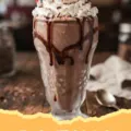 Chocolate Milkshake Recipe - A thick chocolate milkshake in a frosted glass with whipped cream