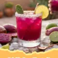 A vibrant pink Prickly Pear Margarita cocktail in a salt-rimmed glass, garnished with a lime wheel, set against a blurred desert-inspired background.