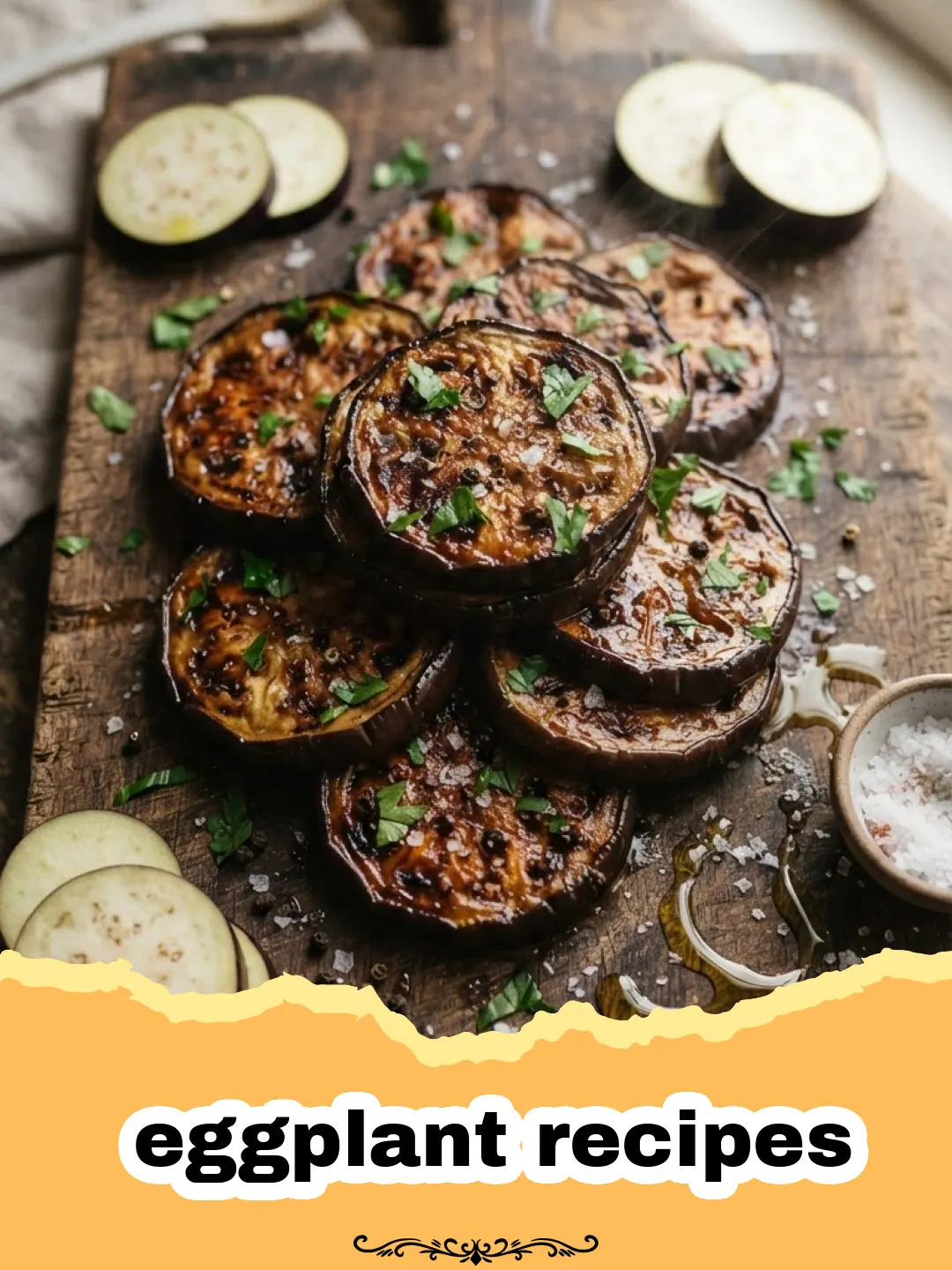 eggplant recipes - Close-up of roasted eggplant slices topped with crumbled feta cheese and fresh green herbs on a rustic platter.