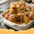 Noodle Kugel With Caramelized Onions & Brown Butter - Close-up of a golden brown Noodle Kugel with caramelized onions and visible noodles, freshly baked in a ceramic dish, ready to be served.