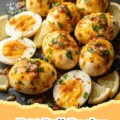 Egg Boil Recipe - A close-up shot of a vibrant, spicy seafood and egg boil served in a large pot, featuring whole hard-boiled eggs, pink shrimp, sliced sausage, corn on the cob, and red potatoes, all coated in a rich, glistening red sauce and garnished with fresh parsley.